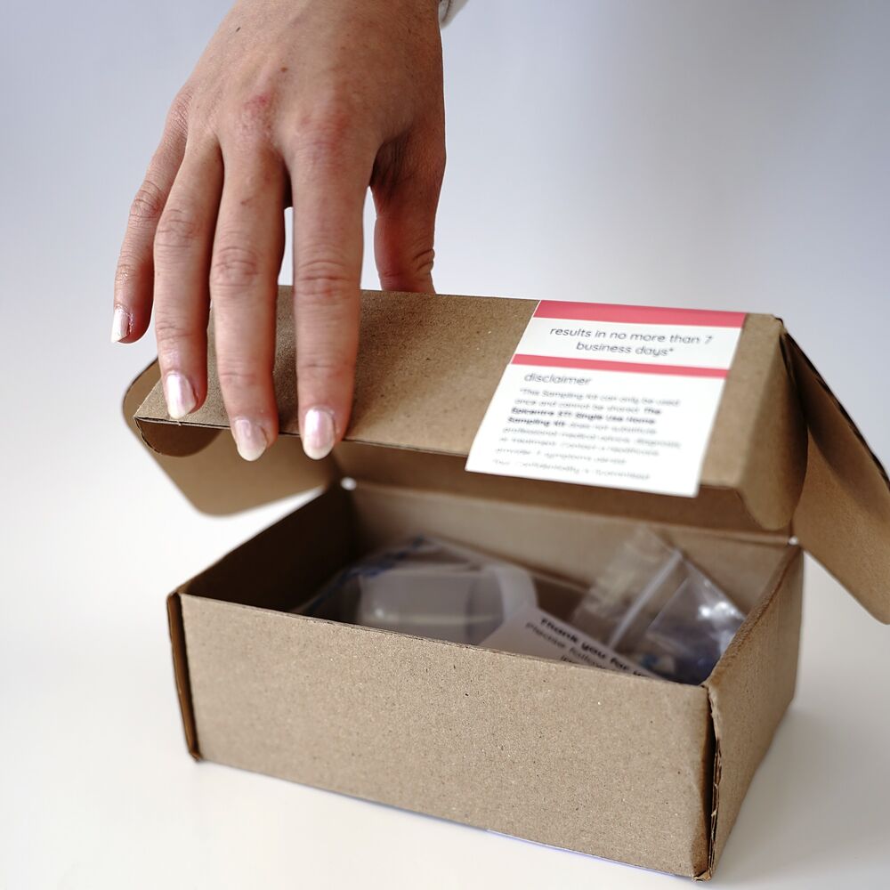 Opening an Epicentre kit box, with the results timeline printed inside the lid